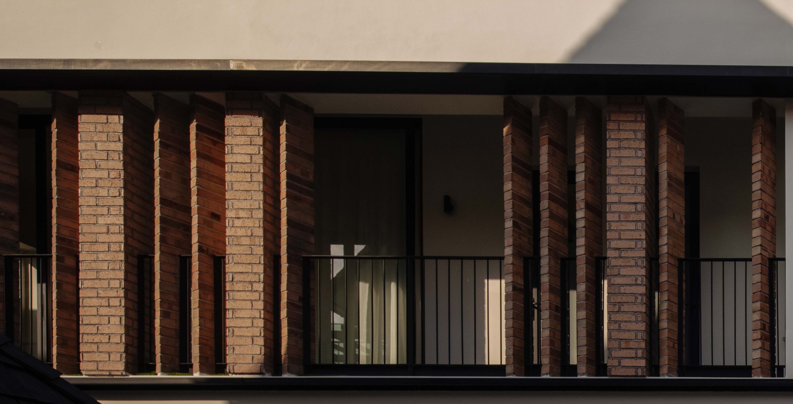 The brick pier feature on the side facade of this semi-detached house by Genome Architects in Bukit Timah.