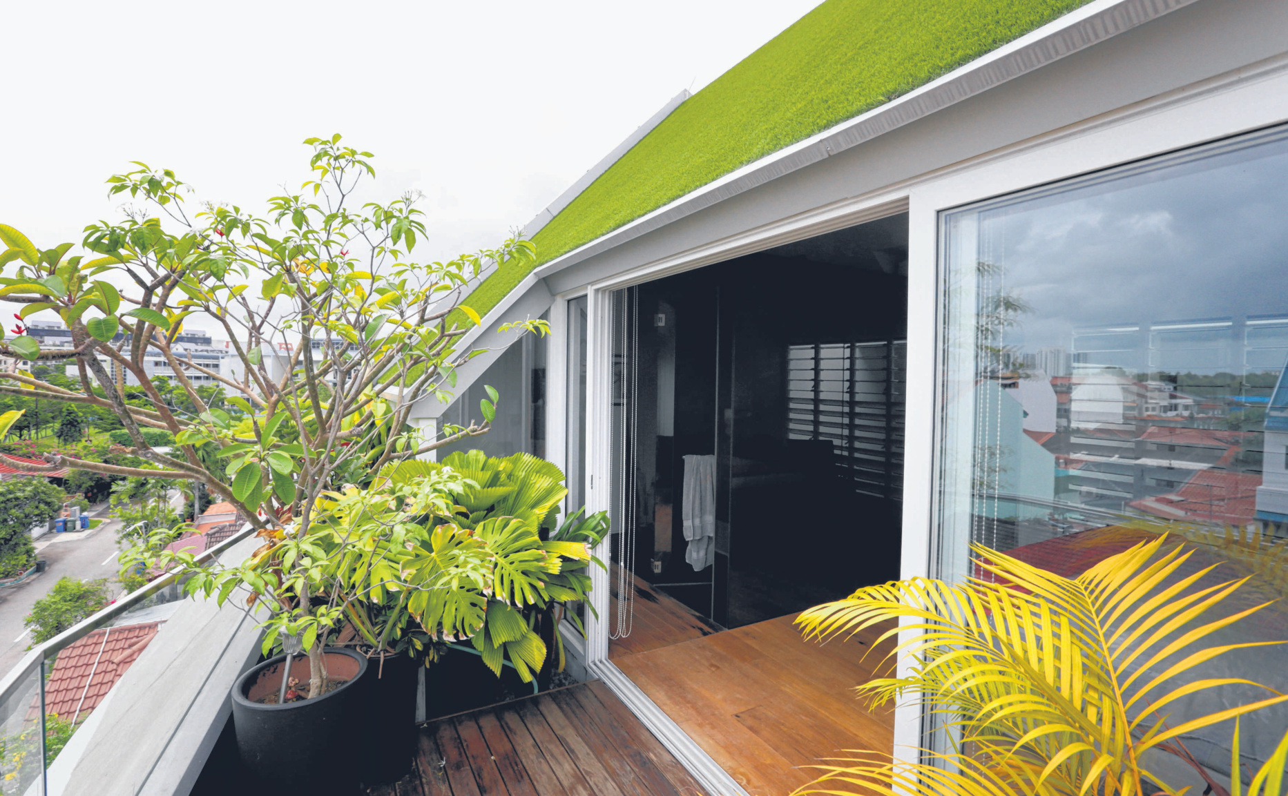 A planted green roof shades the balcony of Helix House, by Genome Architects.